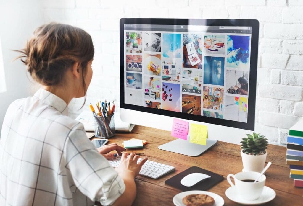 Girl at desk working on social media files on computer